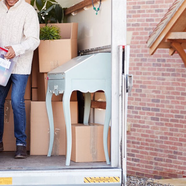 Moving boxes and furniture being loaded for a move estimate