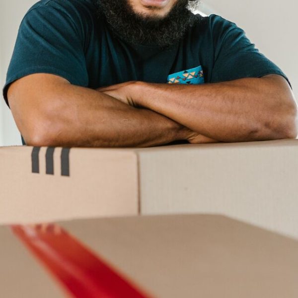 An owner reviewing costs beside a box