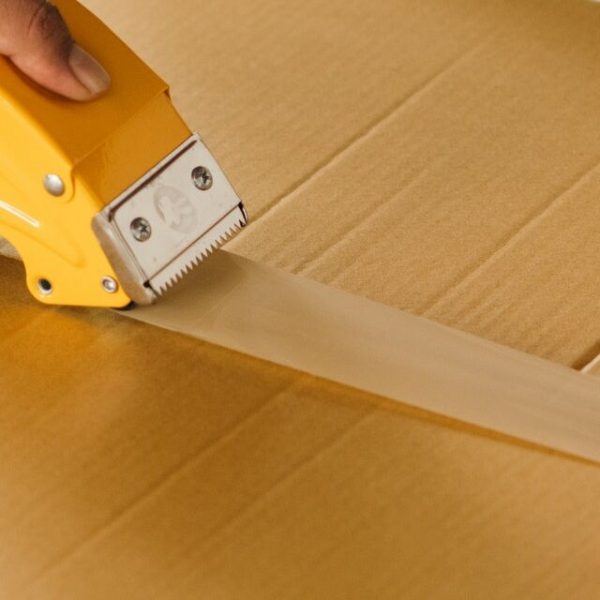Sealing a moving box with a tape gun
